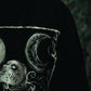 Close up of demonic woman print on Still Cursed long sleeve tee – occult gothic design in water‑based ink
